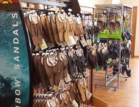 Interior of the Houser Shoes store in Greenwood, showing racks of sandals and Crocs.