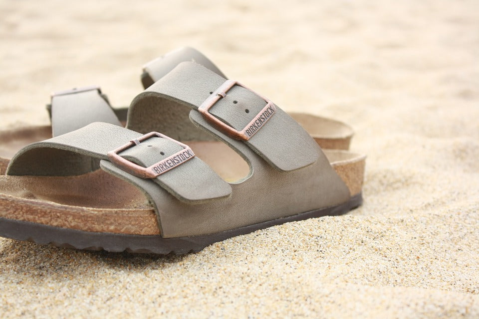 pair of birkenstocks on sand