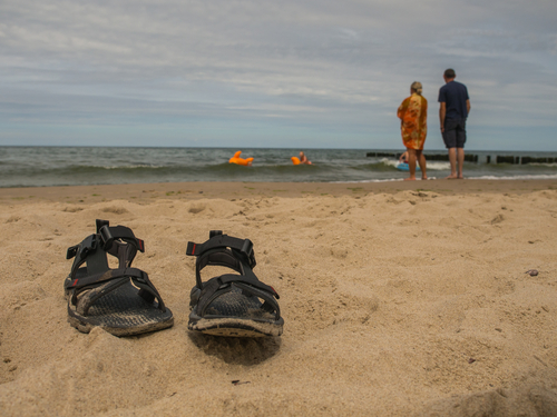 sandals sitting on beach sand