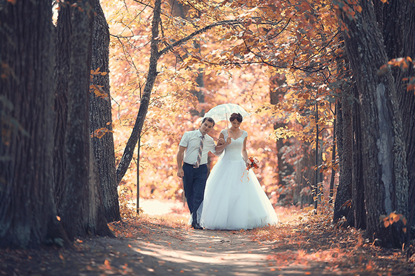 newlyweds walking through woods